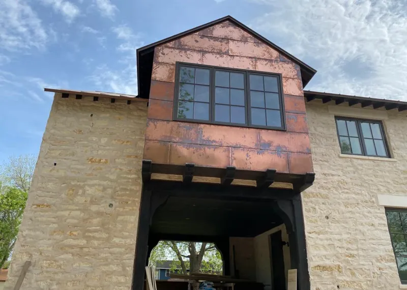 Copper metal panel facade on a stone building for Roof Repair in Helena